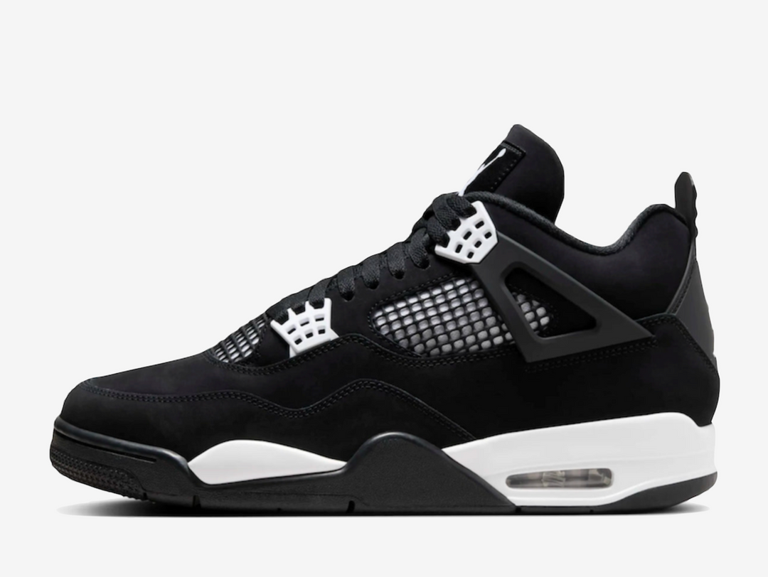 Exclusive Air Jordan 4 sneakers in a black and white colour scheme, featuring a black nubuck upper with white plastic netting on the sides and forefoot.