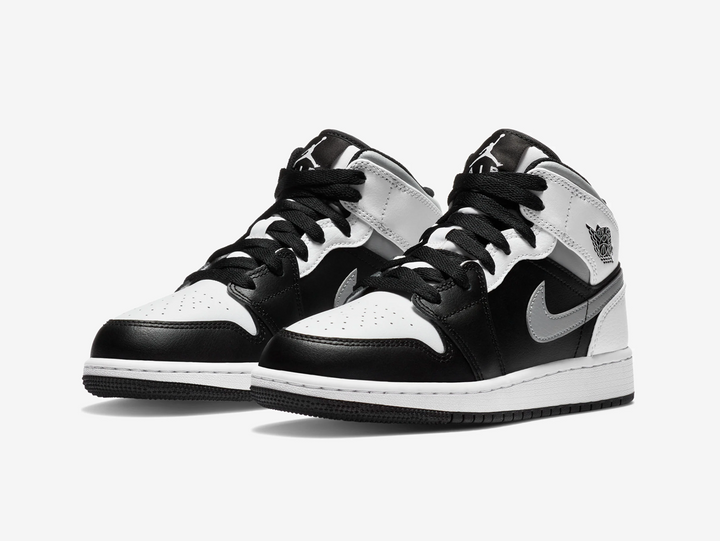Timeless Air Jordan 1 Mid sneakers in a classic white, grey and black colour scheme.