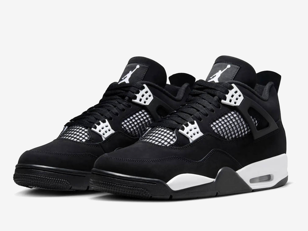 Exclusive Air Jordan 4 sneakers in a black and white colour scheme, featuring a black nubuck upper with white plastic netting on the sides and forefoot. 