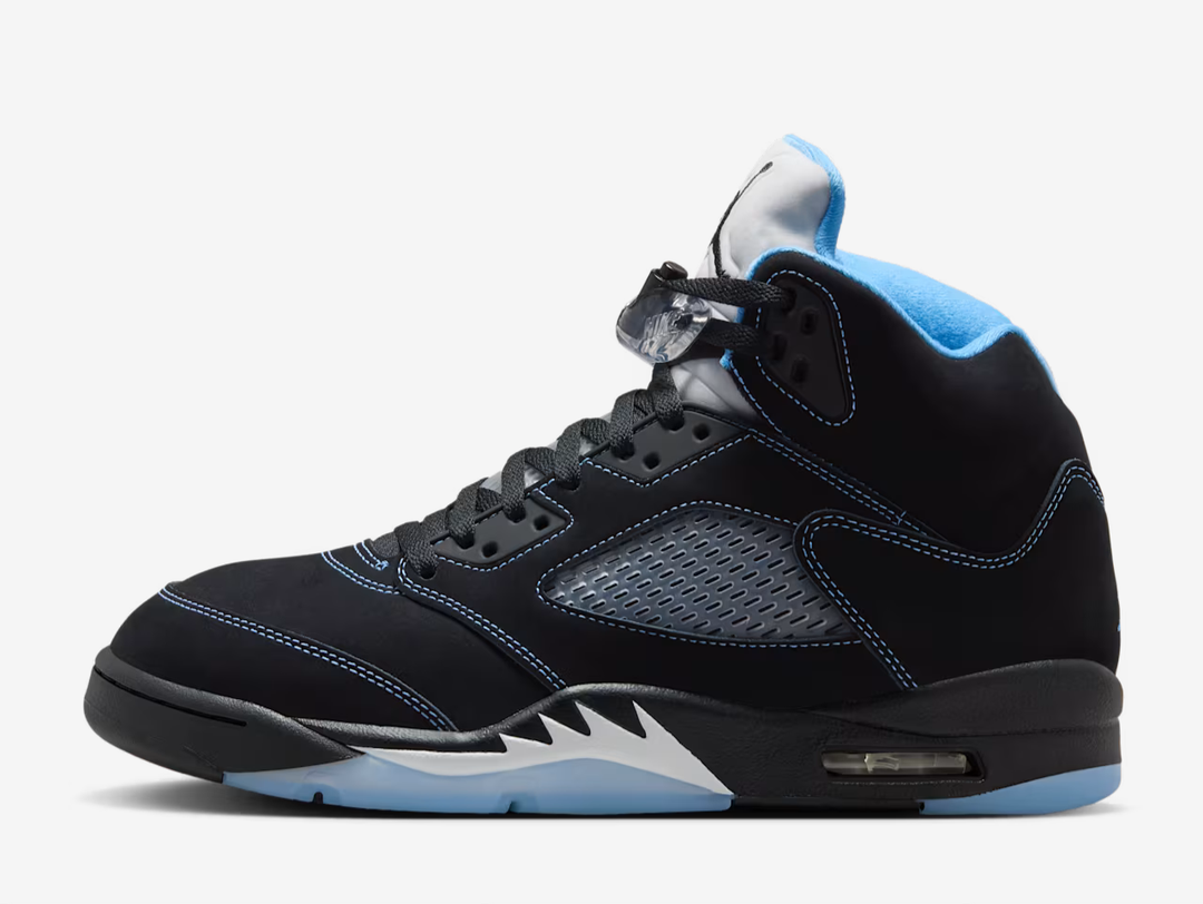 Black nubuck is utilised on the upper, accented with contrast stitching and equipped with translucent quarter panel netting. University Blue textile lines the collar, matching the embroidered Jumpman that adorns the heel. A second Jumpman icon decorates the silver reflective tongue. The sneaker is mounted on a black polyurethane midsole with white shark tooth detailing and a visible Air-Sole unit in the heel. A translucent herringbone-pattern rubber outsole provides grippy traction underfoot.