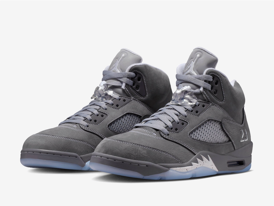 This rendition features a grey nubuck leather upper that feels soft and buttery, while the white contrast stitching highlights the bulky structure. The plastic netting on the quarter covers the mesh side panels for breathability. An embroidered “23” adorns the lateral foxing as a nod to MJ’s jersey number, complementing the trademark Jumpman logo on the rear and puffy tongue. The lace locks and padded collars provide a snug, pillow-like fit around the ankles, ensuring comfort from day to night.