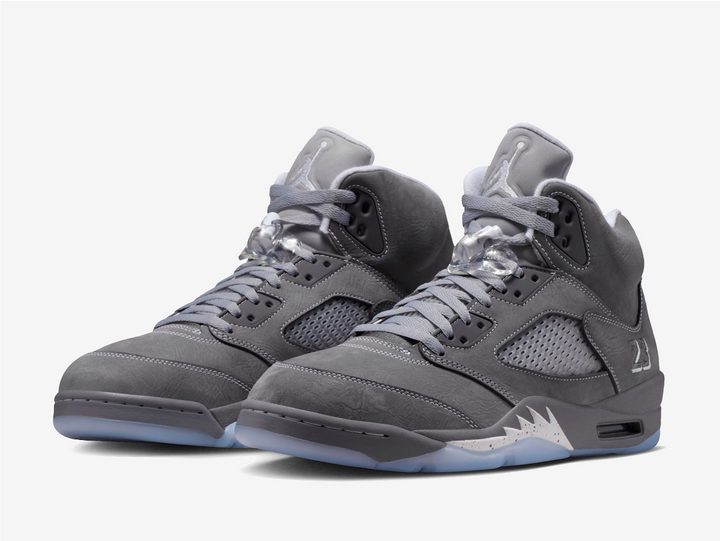 This rendition features a grey nubuck leather upper that feels soft and buttery, while the white contrast stitching highlights the bulky structure. The plastic netting on the quarter covers the mesh side panels for breathability. An embroidered “23” adorns the lateral foxing as a nod to MJ’s jersey number, complementing the trademark Jumpman logo on the rear and puffy tongue. The lace locks and padded collars provide a snug, pillow-like fit around the ankles, ensuring comfort from day to night.