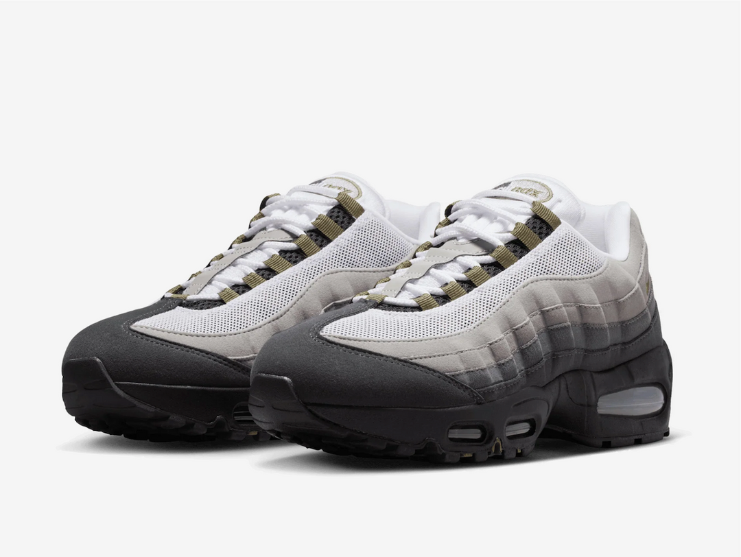 This rendition features the signature greyscale gradient throughout the wavy upper panels, nodding to both the human muscular system and natural erosion. An olive green hue envelops the nylon eyelets and embroidered Swoosh on the lateral section, complementing the pill logo on the tongue and Nike branding on the rear and insole. The stealthy black polyurethane foam midsole surrounds the Big Bubble in the heel and the standard Max Air unit in the forefoot for responsive cushioning and impact protection.