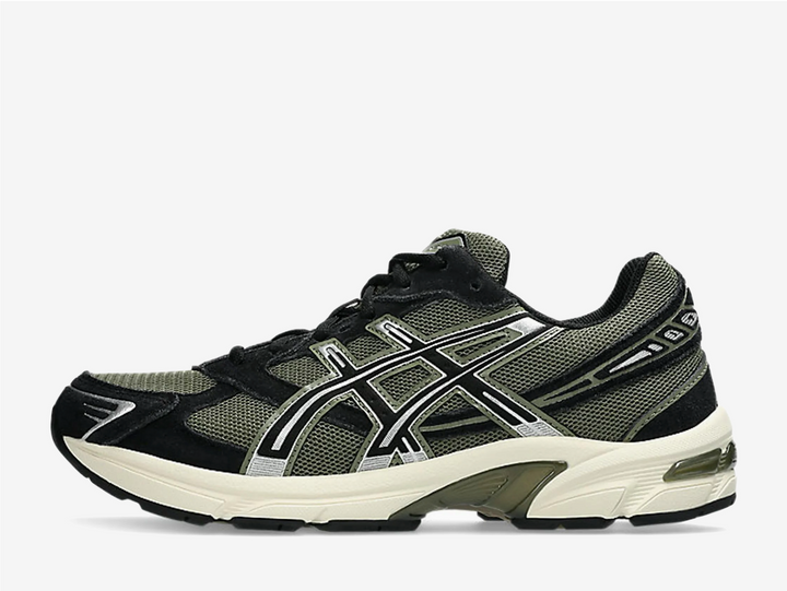 The ASICS GEL-1130 Black Irvine merges retro running DNA with a bold, modern edge, featuring breathable mesh underlays and layered synthetic panels in a dark black base with striking Irvine green accents. Heel GEL cushioning delivers dependable shock absorption while the TRUSSTIC support system provides lightweight stability, making this pair a comfortable, everyday trainer that stands out without sacrificing versatility.