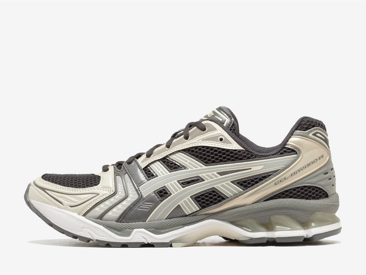 The moody obsidian upper creates depth against cement grey accents, while the distinctive layered design channels the technical heritage that made this trainer model legendary. Marking a pivotal moment in the Gel-Kayano timeline as the first edition designed beyond the original creator's hand, this resurrection maintains the revolutionary GEL technology that redefined impact absorption. 
