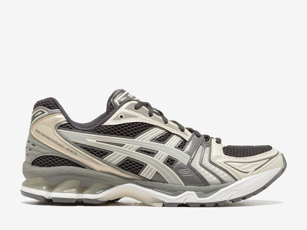 The moody obsidian upper creates depth against cement grey accents, while the distinctive layered design channels the technical heritage that made this trainer model legendary. Marking a pivotal moment in the Gel-Kayano timeline as the first edition designed beyond the original creator's hand, this resurrection maintains the revolutionary GEL technology that redefined impact absorption. 