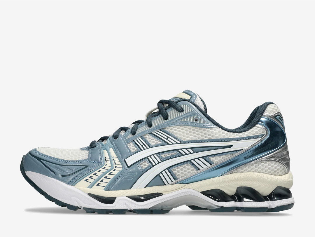 Rooted in retro performance, the ASICS GEL-Kayano 14 "Raw Indigo" offers a subtle shift from the familiar, where off-white foundations meet the unexpected pull of pale blue overlays. A mesh base keeps things breathable and true to the throwback blueprint, while the rare indigo accents introduce quiet intrigue across the upper. Blacked-out GEL cushioning underfoot adds an uncommon edge, balancing the nostalgic neutral palette with modern contrast.