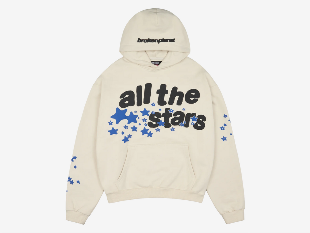 This hoodie features 540 GSM organic cotton fabric with a puff print design accented by rhinestone studs. It includes a soft brushed cotton inner lining, a Sun logo tab on the pocket, and a boxy fit for a contemporary look.