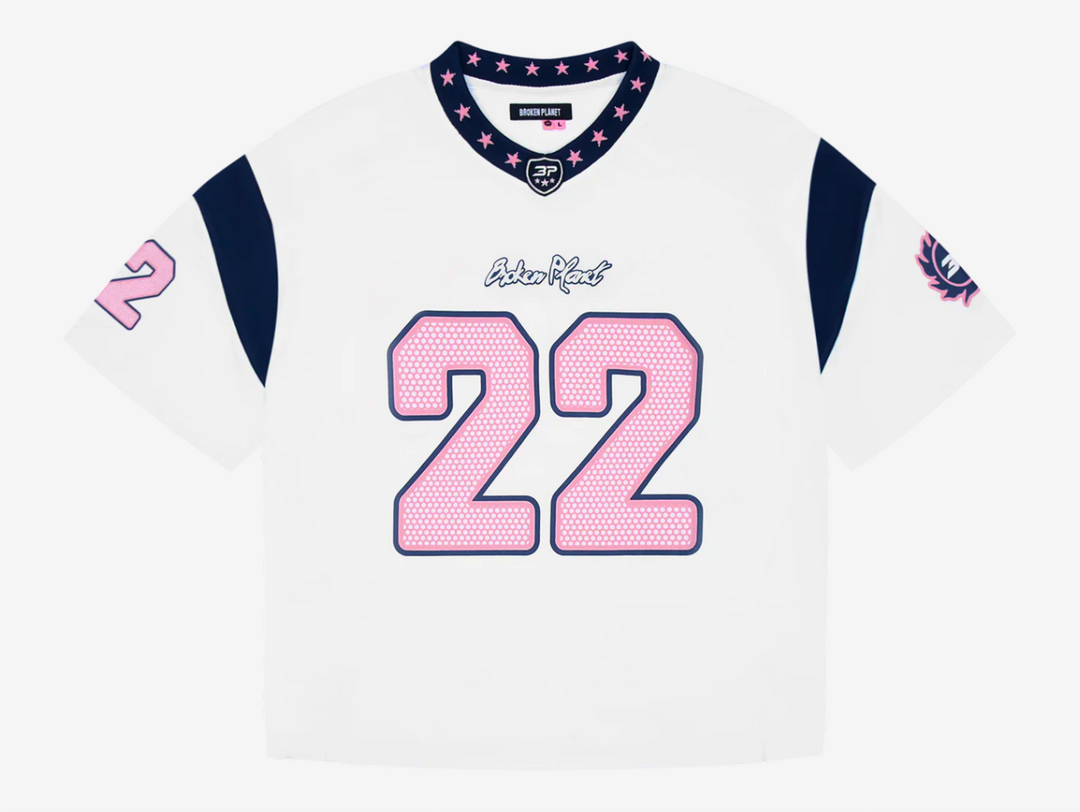 This jersey is made from recycled polyester fabric, combining sustainability with performance. It features a mix of puff and screen prints across the chest, sleeves, and back for a dynamic, layered look. A woven star neck rib adds a unique design detail, while an embroidered patch on the neck enhances the premium finish. The jersey fits true to size, offering comfort without compromising style.