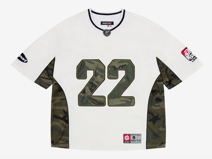 This jersey is made from a recycled polyester base and lining, offering a sustainable edge with a premium feel. Designed with a boxy fit for a modern, relaxed silhouette, it features satin appliqué embroidery paired with a silicone print on the back, delivering bold texture and depth. Metallic print graphics add a striking visual impact, while an embroidered neck patch and woven label complete the design with elevated detail.