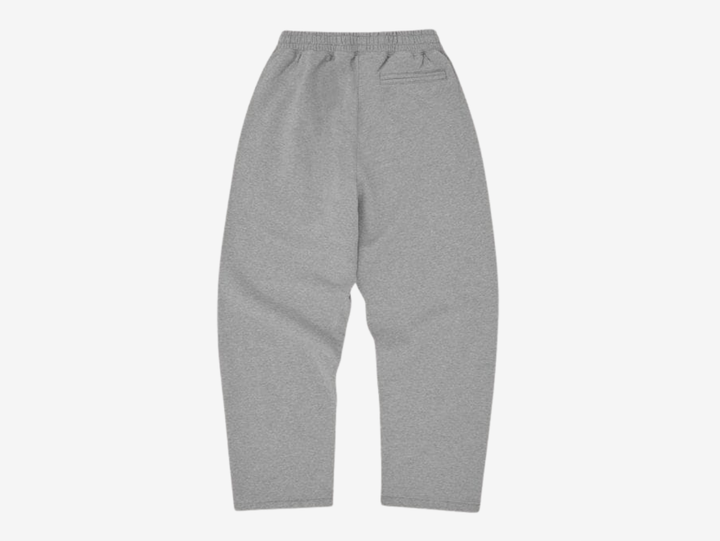 Crafted from heavyweight 440GSM 100% cotton with a soft fleece-lined interior, the Corteiz Colly Arch Logo Sweatpants deliver premium comfort and everyday durability. Designed with coverstitch detailing throughout, they feature a raw edge Corteiz RTW logo on the left leg, an adjustable drawstring with an elasticated waistband, and a practical rear pocket. Finished with an open hem and a true-to-size fit, these sweatpants offer a clean, relaxed silhouette with signature Corteiz styling.