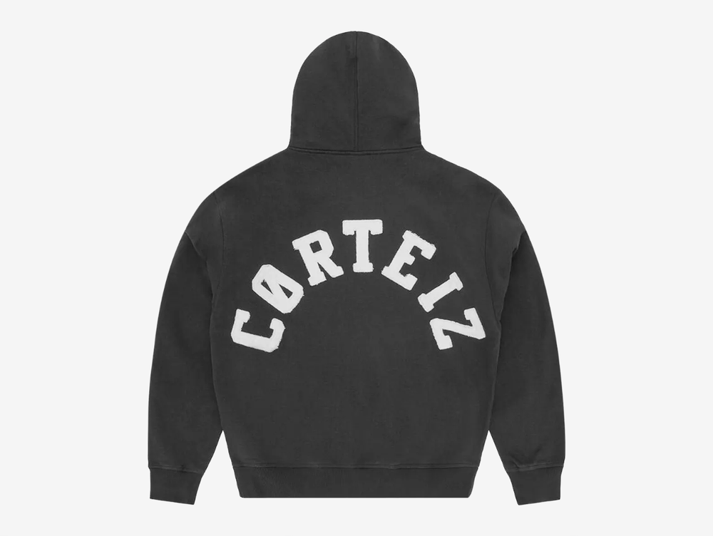 Built with premium quality and clean everyday styling, the Corteiz Colly Arch Logo Zip Up Hoodie is crafted from heavyweight 440GSM 100% cotton for a structured yet comfortable feel. Designed with a boxy, dropped-shoulder fit, it features a raw edge Corteiz logo on the left chest, durable overlock stitching throughout, and high-quality YKK metal zippers. Finished with a soft fleece-lined interior, ribbed cuffs and hem, this hoodie delivers warmth and durability in a versatile black colourway.