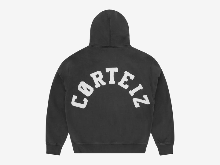 Built with premium quality and clean everyday styling, the Corteiz Colly Arch Logo Zip Up Hoodie is crafted from heavyweight 440GSM 100% cotton for a structured yet comfortable feel. Designed with a boxy, dropped-shoulder fit, it features a raw edge Corteiz logo on the left chest, durable overlock stitching throughout, and high-quality YKK metal zippers. Finished with a soft fleece-lined interior, ribbed cuffs and hem, this hoodie delivers warmth and durability in a versatile black colourway.