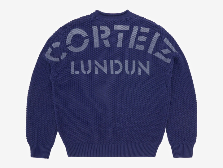 Crafted from a 100% cotton heavy knit, this sweater delivers warmth, structure, and an elevated hand-feel. It’s designed with a clean rolled neckline, ribbed cuffs and hem for a secure fit, and a woven label on the lower left for subtle detailing. Finished with bold Corteiz branding screen-printed across the back, it blends comfort with signature identity.
