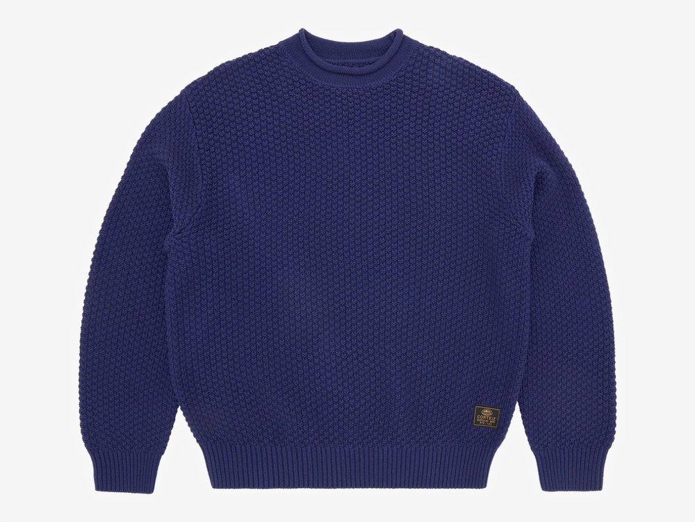 Crafted from a 100% cotton heavy knit, this sweater delivers warmth, structure, and an elevated hand-feel. It’s designed with a clean rolled neckline, ribbed cuffs and hem for a secure fit, and a woven label on the lower left for subtle detailing. Finished with bold Corteiz branding screen-printed across the back, it blends comfort with signature identity.