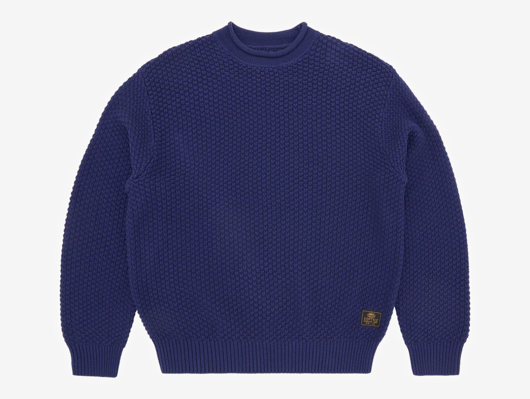 Crafted from a 100% cotton heavy knit, this sweater delivers warmth, structure, and an elevated hand-feel. It’s designed with a clean rolled neckline, ribbed cuffs and hem for a secure fit, and a woven label on the lower left for subtle detailing. Finished with bold Corteiz branding screen-printed across the back, it blends comfort with signature identity.