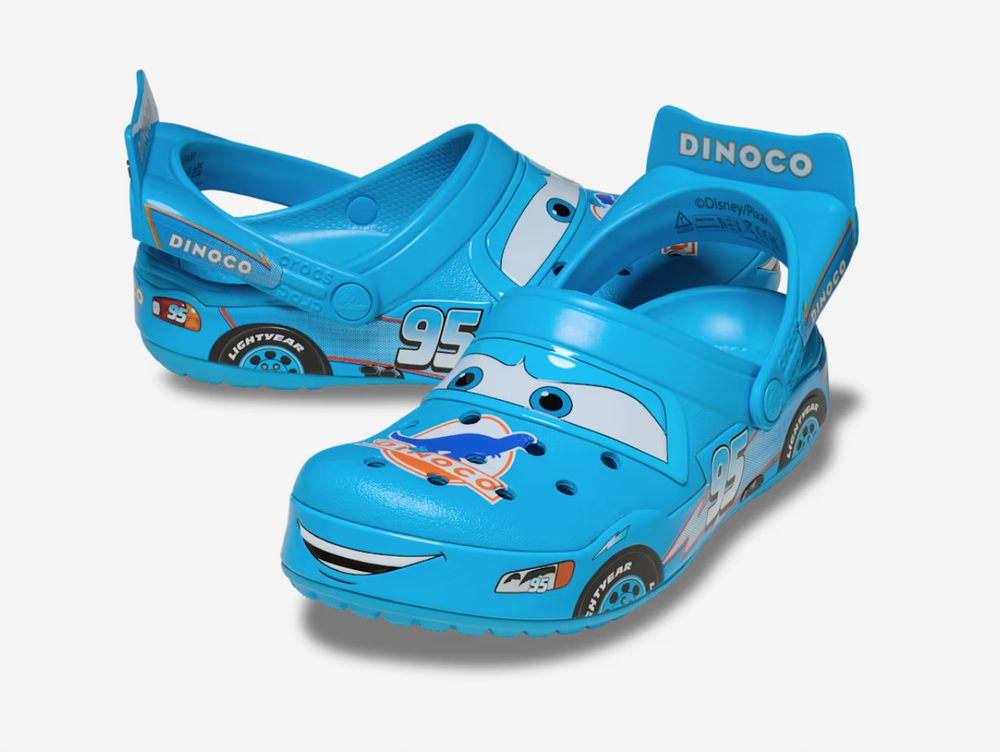 The Crocs Classic Clog Dinoco brings a bold racing-inspired look to the iconic clog silhouette, finished in bright blue with Dinoco graphics, racing numbers and character-inspired detailing throughout. Lightweight Croslite™ construction, ventilation ports and an adjustable heel strap provide the signature comfort and easy fit Crocs are known for.