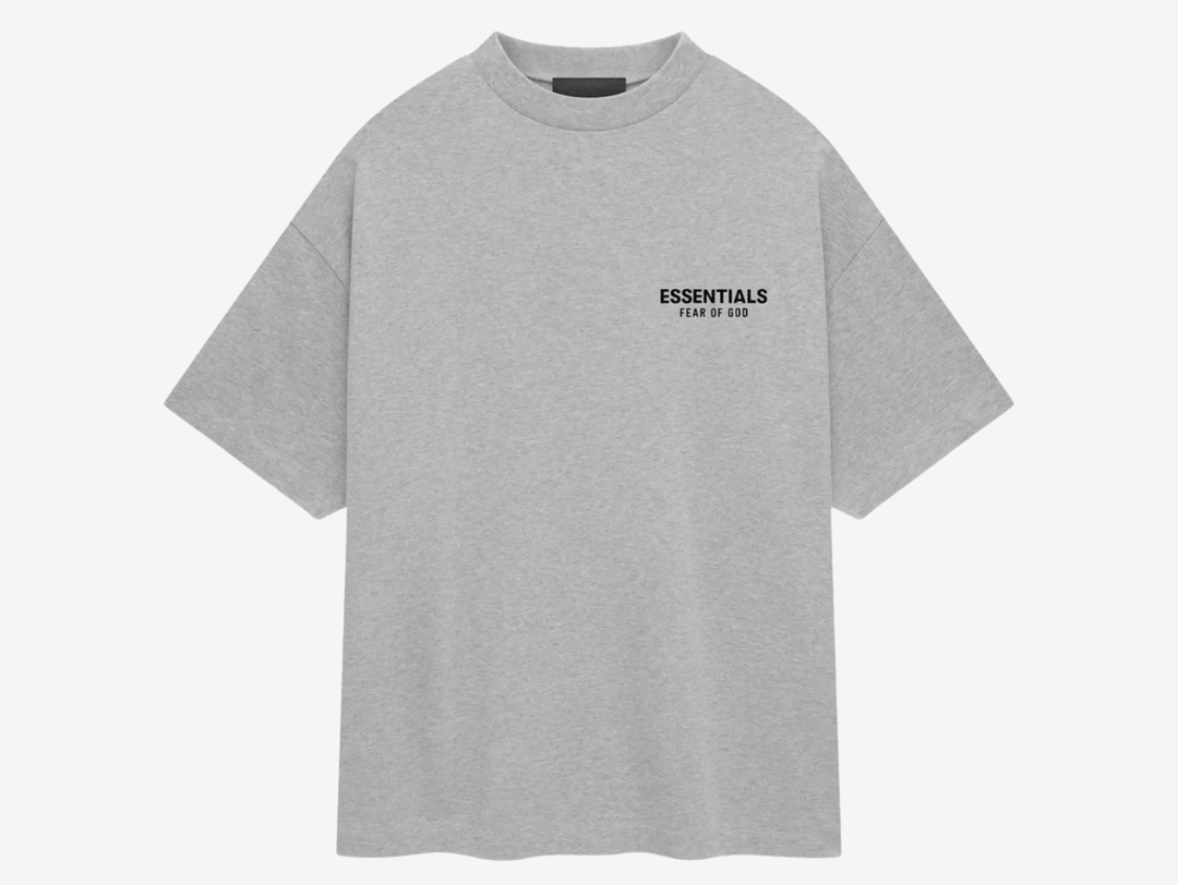 The t-shirt has a minimalistic aesthetic with thoughtful details such as the "Essentials Fear of God" logo placed on both the chest and back with an understated rubberized tag at the back collar. The colorway of the gray of the material and the black logo texts adds to the minimal look and makes it a versatile piece.