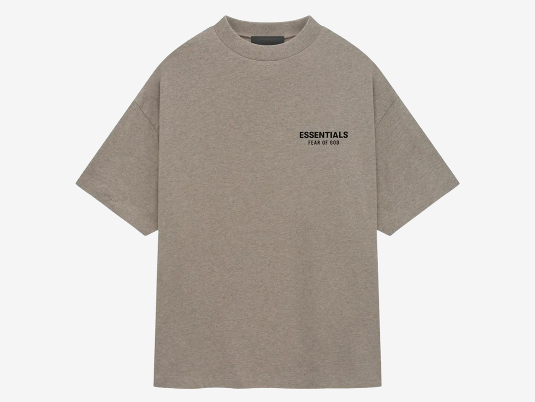 The tee showcases an oversized fit with a ribbed crew neck, short sleeves, and dropped shoulders. Sticking to the minimalist theme, the T-shirt features subtle but impactful branding on the left chest and back, showcasing the "ESSENTIALS FEAR OF GOD" soft-touch logo graphics in black. The Heather Gray tee finishes with a rubber logo patch on the back.