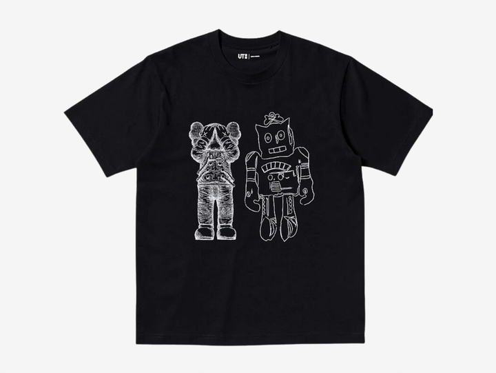 Black crewneck T-shirt with a white UT logo on the chest label, featuring a white line-art print of a KAWS Companion figure standing beside a boxy robot character, both in a sketchy hand-drawn style, centered on the chest.