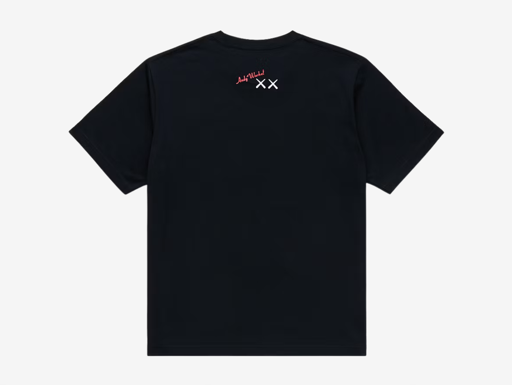 Black crewneck T-shirt with a white UT logo on the chest label, featuring a white line-art print of a KAWS Companion figure standing beside a boxy robot character, both in a sketchy hand-drawn style, centered on the chest.