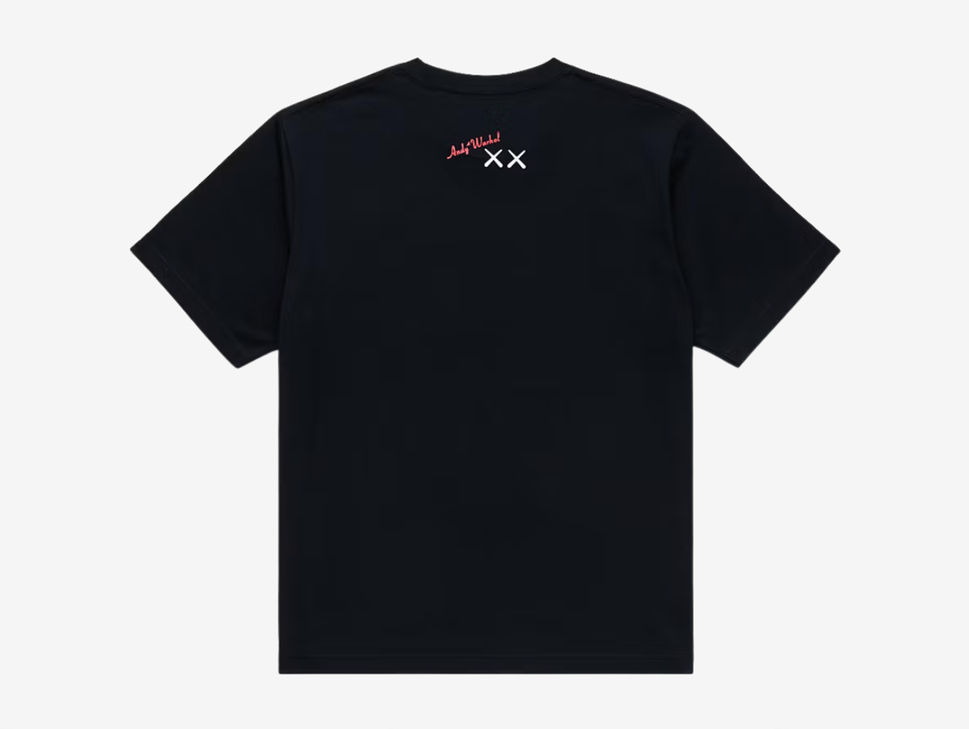 Black crewneck T-shirt with a white UT logo on the chest label, featuring a white line-art print of a KAWS Companion figure standing beside a boxy robot character, both in a sketchy hand-drawn style, centered on the chest.