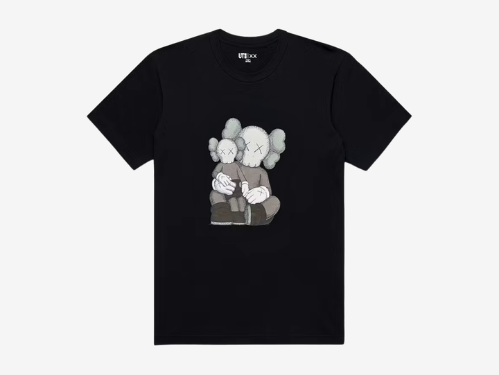 The KAWS x Uniqlo Graphic T-shirt in Black showcases one of KAWS' most recognisable Companion artworks with a large embroidered-style front graphic. Crafted from soft 100% cotton, it offers a comfortable everyday fit while combining clean, minimal styling with the artist's signature contemporary aesthetic. Perfect for collectors and fans of KAWS' iconic collaborations.