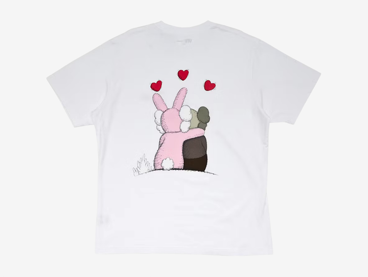 The KAWS x Uniqlo Warhol UT Graphic 476350 T-shirt in White combines KAWS' signature characters with Andy Warhol-inspired artwork in a clean, wearable design. Crafted from 100% cotton, it features a subtle embroidered lips graphic on the chest, while the back showcases an embroidered KAWS Companion embracing the Pink BFF beneath three red hearts, creating a playful yet collectible finish.