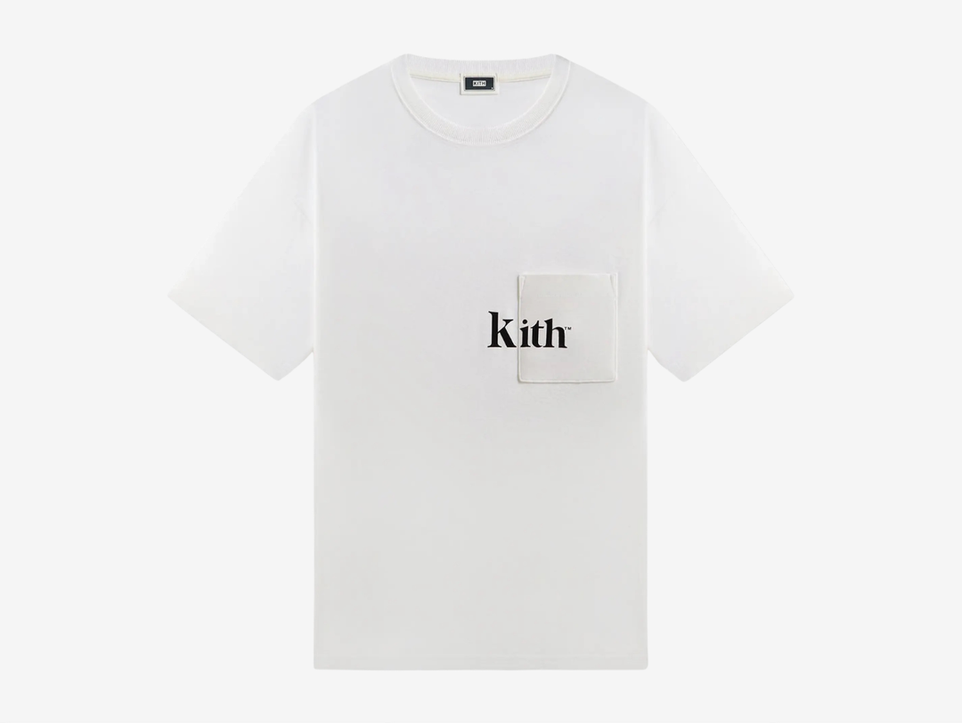 The Quinn Tee is crafted of 265 GSM cotton jersey that is washed for a soft hand feel. It features a ribbed neckline, patch pockets at the chest with flocked Kith artwork, and slit at the seams.