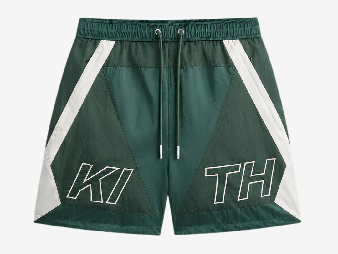 Kith Washed Nylon Shorts in Green, designed with a lightweight washed nylon build, relaxed fit, elasticated waistband, and functional pockets. Finished in a rich green colourway with signature Kith detailing for comfortable everyday styling.