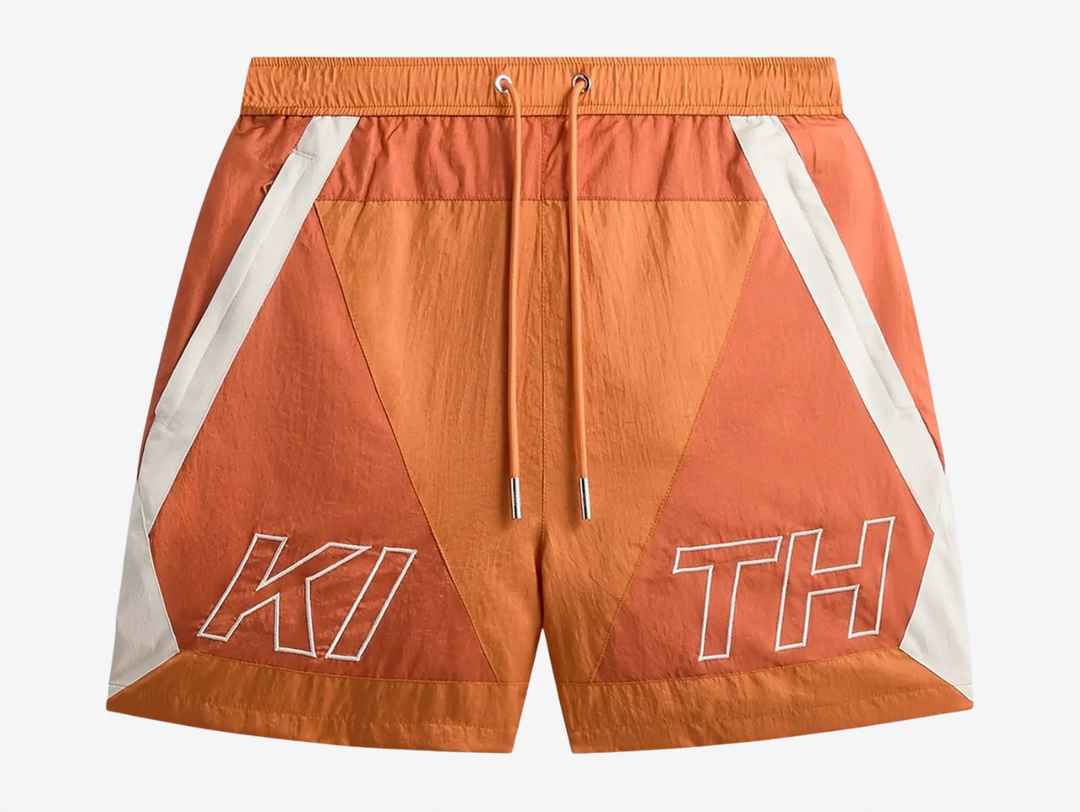 Kith Washed Nylon Shorts in Clementine, featuring a lightweight washed nylon construction, relaxed fit, elasticated waistband, and practical pocket detailing. Finished in a bold orange colourway with subtle Kith branding, bringing a standout look to any wardrobe.