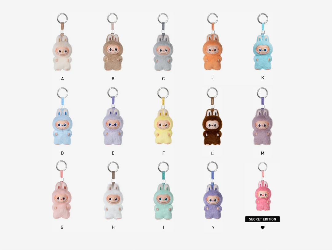 This Pop Mart Labubu The Monsters: Pin For Love Set includes a sealed collection of 14 blind-box plush pendant keychains — from letters A through M — each featuring the mischievous Labubu character rendered in a soft plush exterior and durable vinyl shell. Designed to clip onto bags, keys, or phone straps, each pendant carries its own unique personality and charm, encapsulating the playful love-letter motif of the series.
