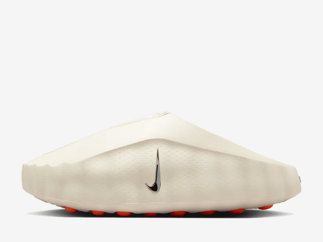 Built with sculptural minimalism in mind, the design refuses to overcomplicate. Subtle perforations let your feet breathe, while minimal branding on the footbed keeps the focus where it belongs. Below, 22 vivid orange pods spike the outsole in Hyper Crimson, delivering traction with theatre and grounding the avant garde silhouette in something wearable, functional and unmistakably Nike.