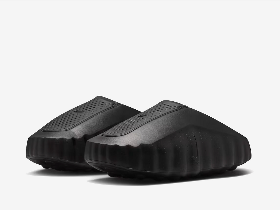 Black covers every surface, from the columned side panels to the perforated tongue and smooth upper, creating a seamless monochrome canvas. The raised side structure and moulded textures remain the focal points, while the 22 underfoot nodes blend into the build rather than demand attention. Pressed logos on the tongue and subtle vertical Swooshes keep branding whisper quiet, making this a silhouette for those drawn to design over decoration.