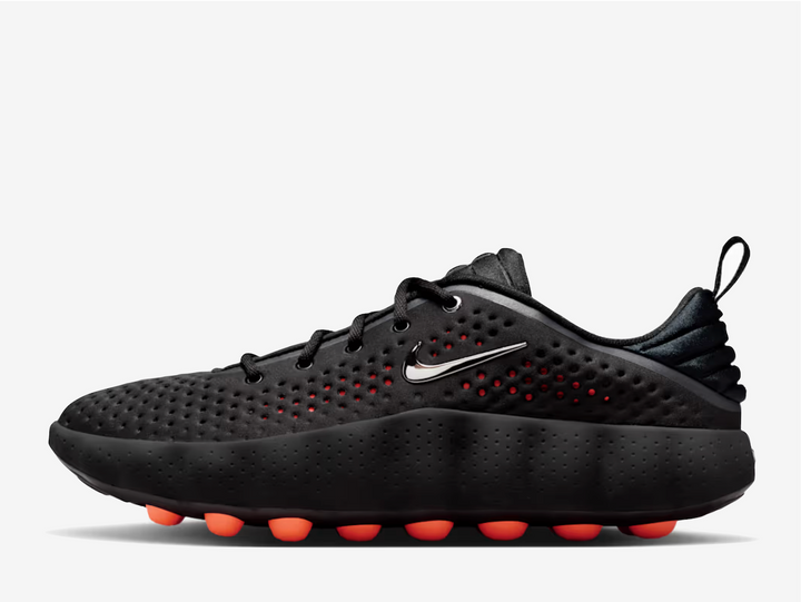 This 002 dons a black knitted textile upper with engineered perforations for a lightweight and breathable feel. A metallic silver Swoosh rests on the padded tongue and sidewall, complementing the chromed-out Nike branding on the rear. The traditional lacing system and puffy heel counter provide a secure fit. The chunky foam midsole delivers excellent cushioning and impact absorption underfoot. 22 spherical orange foam nodes target your foot’s pressure points, offering a mind-altering experience.