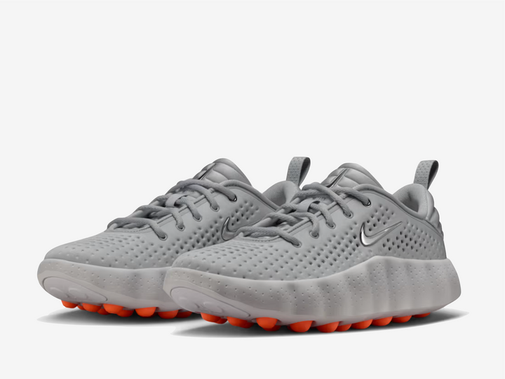 This 002 dons a grey knitted textile upper with engineered perforations for a lightweight and breathable feel. A metallic silver Swoosh rests on the padded tongue and sidewall, complementing the chromed-out Nike branding on the rear. The traditional lacing system and puffy heel counter provide a secure fit. The chunky foam midsole delivers excellent cushioning and impact absorption underfoot. 22 spherical orange foam nodes target your foot’s pressure points, offering a mind-altering experience.