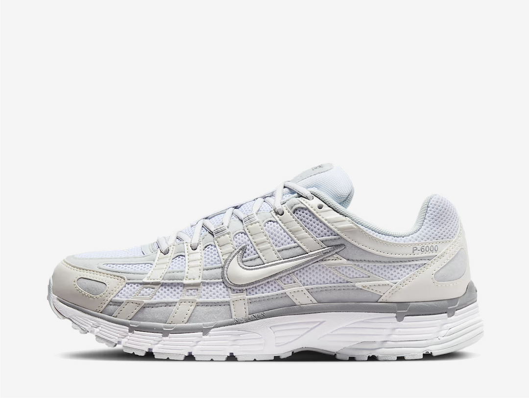 zeitgeist. This colourway has a light purple tinge encompassing the open mesh underlay with sail white and grey tones surrounding the synthetic leather and suede overlays. Signature profile Swooshes on the sides are made prominent by neatly embroidered outlines, giving them an oversized aesthetic. Embossed P-6000 branding adorns the lateral rear, while classic Swoosh logos appear on the sockliner and heel tab.