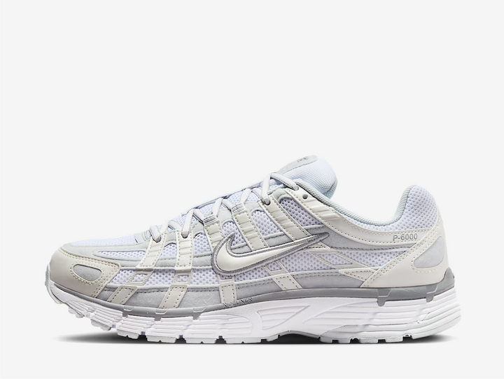 zeitgeist. This colourway has a light purple tinge encompassing the open mesh underlay with sail white and grey tones surrounding the synthetic leather and suede overlays. Signature profile Swooshes on the sides are made prominent by neatly embroidered outlines, giving them an oversized aesthetic. Embossed P-6000 branding adorns the lateral rear, while classic Swoosh logos appear on the sockliner and heel tab.