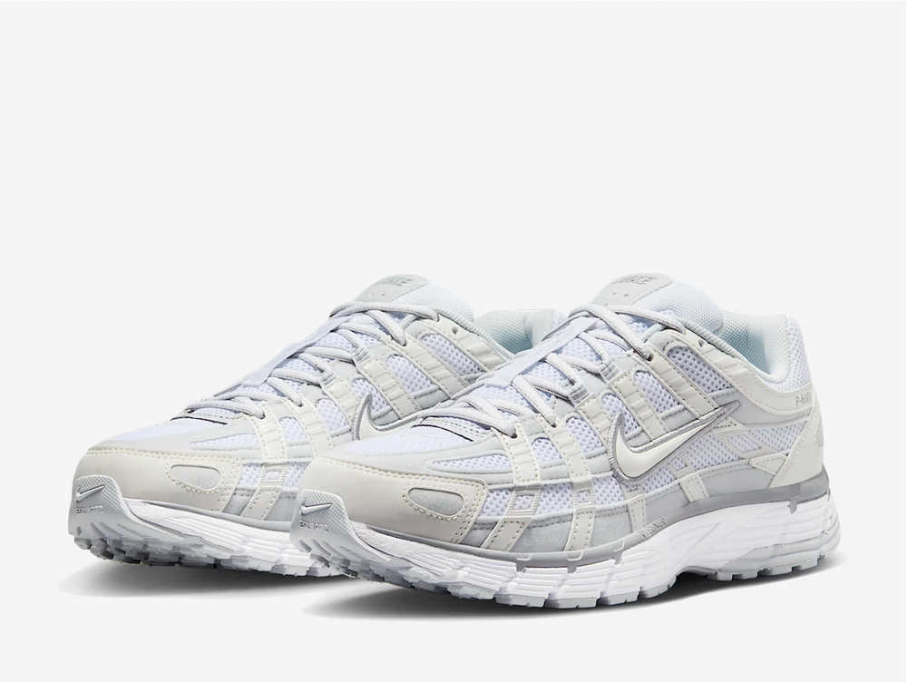 zeitgeist. This colourway has a light purple tinge encompassing the open mesh underlay with sail white and grey tones surrounding the synthetic leather and suede overlays. Signature profile Swooshes on the sides are made prominent by neatly embroidered outlines, giving them an oversized aesthetic. Embossed P-6000 branding adorns the lateral rear, while classic Swoosh logos appear on the sockliner and heel tab.