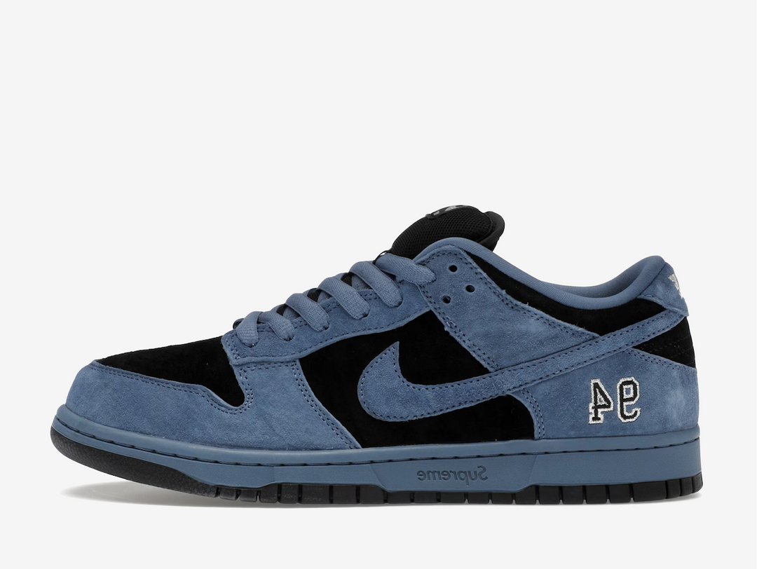 This special-edition skate shoe flaunts a two-tone palette, kitted in beige suede underlays with blue velvet overlays. Dark blue Swooshes grace the sidewalls, whilst the vibrant orange inner lining, a shared detail across all three colourways, contrasts the predominantly cool-coloured sneaker. An engraved Supreme label adorns the midsole, complementing the embroidered “94” on the lateral foxing. Co-branding on the tongue and sockliner set this exclusive SB apart.
