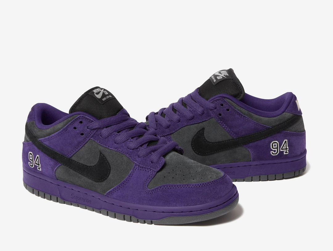 This skate shoe features a dark grey suede upper with a black Swoosh and purple accents. An embroidered “94” on the lateral foxing nods to the brand’s Manhattan origins, while a debossed Supreme label, co-branded sockliners, and orange hangtag add signature touches. Classic SB details appear on the heel tabs and puffy tongue, with Zoom cushioning in the heel for impact protection. Extra black laces offer versatile styling for skate or casual wear.
