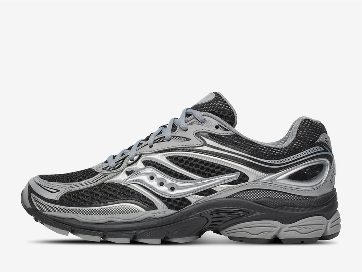 The Saucony ProGrid Omni 9 ‘Black Silver’ fuses classic supportive running DNA with a sleek monochrome palette, delivering understated style and dependable performance. The breathable black mesh upper is reinforced with silver synthetic overlays, offering a clean, structured design that transitions effortlessly from athletic endeavors to urban outings. Minimal Saucony branding ensures a refined look, while crisp two-tone lines give the trainer a sharp, streamlined silhouette ideal for everyday wear.