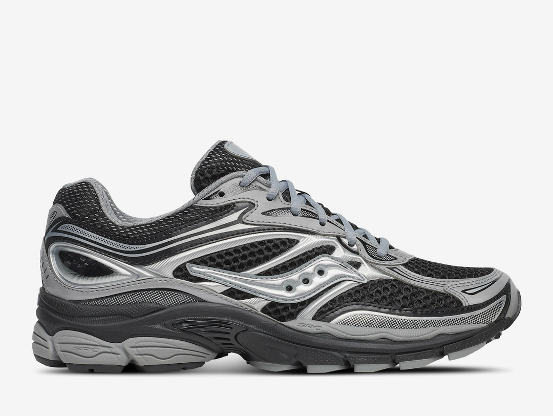 The Saucony ProGrid Omni 9 ‘Black Silver’ fuses classic supportive running DNA with a sleek monochrome palette, delivering understated style and dependable performance. The breathable black mesh upper is reinforced with silver synthetic overlays, offering a clean, structured design that transitions effortlessly from athletic endeavors to urban outings. Minimal Saucony branding ensures a refined look, while crisp two-tone lines give the trainer a sharp, streamlined silhouette ideal for everyday wear.