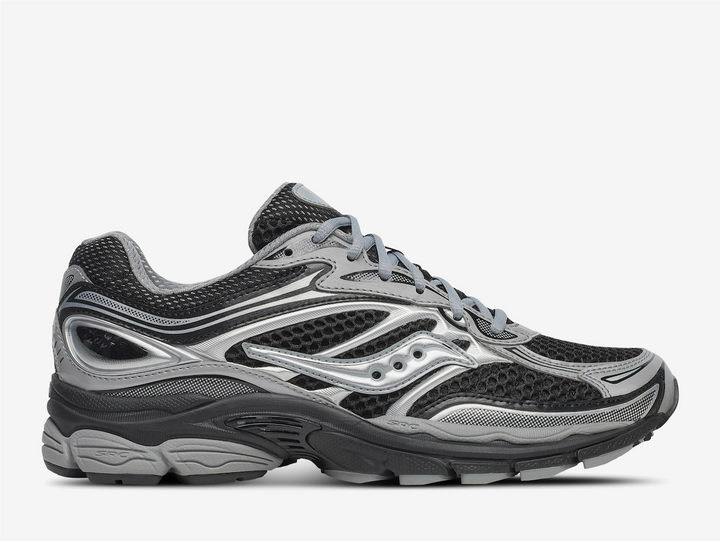 The Saucony ProGrid Omni 9 ‘Black Silver’ fuses classic supportive running DNA with a sleek monochrome palette, delivering understated style and dependable performance. The breathable black mesh upper is reinforced with silver synthetic overlays, offering a clean, structured design that transitions effortlessly from athletic endeavors to urban outings. Minimal Saucony branding ensures a refined look, while crisp two-tone lines give the trainer a sharp, streamlined silhouette ideal for everyday wear.