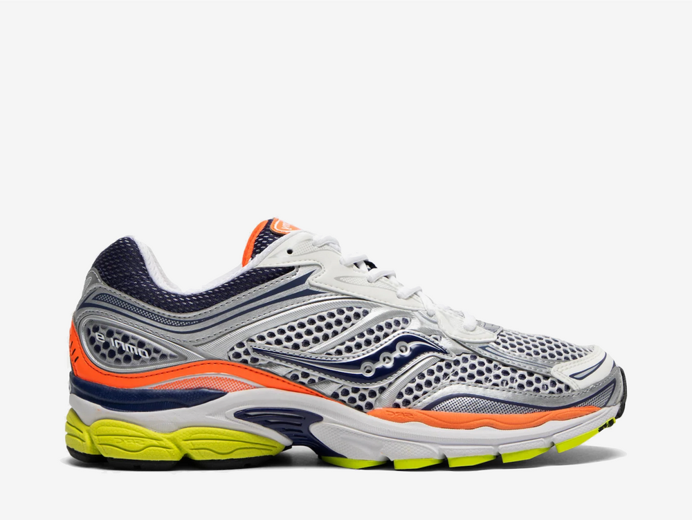 The Saucony ProGrid Omni 9 Silver Navy Orange combines silver mesh and overlays with navy detailing, bright orange accents and a volt outsole. ProGrid cushioning underfoot provides everyday comfort, while the bold colour blocking gives the retro runner a more energetic finish.