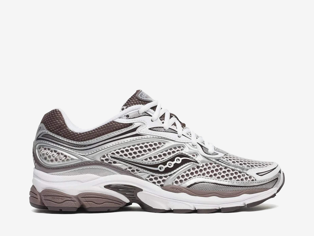 The Saucony ProGrid Omni 9 Silver White Brown features a breathable silver and white mesh upper with layered metallic overlays and muted brown accents. ProGrid cushioning and a chunky rubber outsole complete the pair with a comfortable feel and classic retro-running aesthetic.