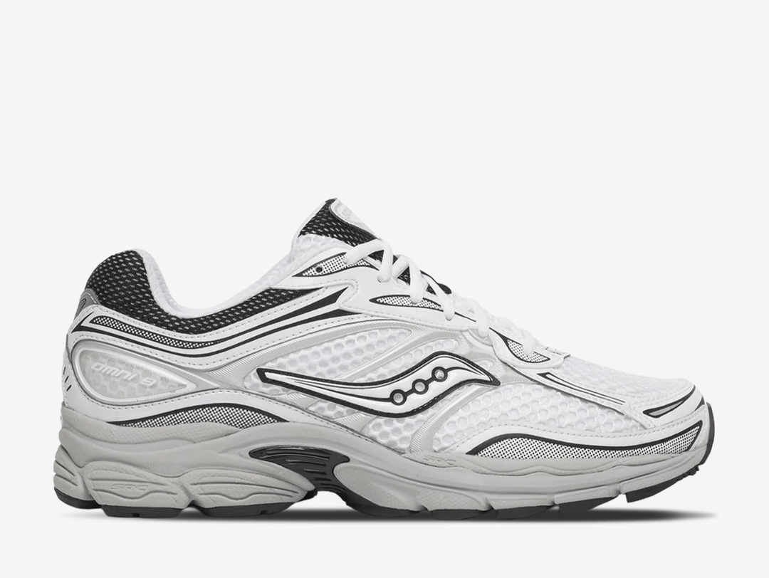 Saucony ProGrid Omni 9 trainers in the White Cadet colourway, featuring breathable white mesh uppers, metallic silver overlays, navy blue detailing, classic Saucony branding and a cushioned retro running sole.
