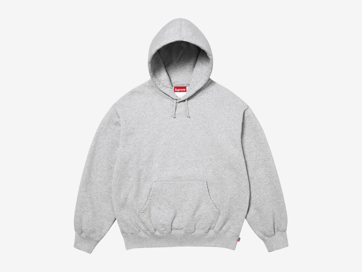 The Supreme Appliqué Logo Hoodie in Grey offers a clean, versatile look with soft, heavyweight fleece for steady comfort. The appliqué Supreme logo across the chest adds texture and a strong focal point without feeling loud. A roomy hood, kangaroo pocket, and ribbed trims keep the fit secure and easy to wear. The neutral grey colorway pairs well with almost anything, making this hoodie a dependable choice for anyone who wants classic Supreme style with refined detail.