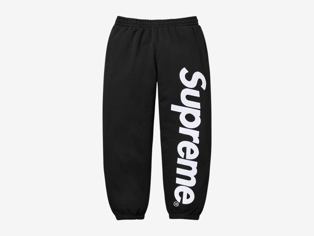 The Supreme Appliqué Logo Sweatpants in Black offer a clean, elevated take on everyday comfort. Made from soft, heavyweight fleece, they feature a bold appliqué Supreme logo along the leg for added texture and detail. The elastic waistband with an adjustable drawcord gives a secure fit, and the relaxed silhouette keeps them easy to wear. The black colorway stays versatile and simple to style. These sweatpants suit anyone who wants classic Supreme comfort with a sharp visual edge.