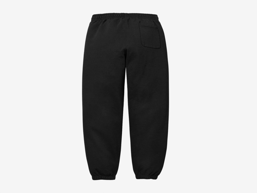 The Supreme Appliqué Logo Sweatpants in Black offer a clean, elevated take on everyday comfort. Made from soft, heavyweight fleece, they feature a bold appliqué Supreme logo along the leg for added texture and detail. The elastic waistband with an adjustable drawcord gives a secure fit, and the relaxed silhouette keeps them easy to wear. The black colorway stays versatile and simple to style. These sweatpants suit anyone who wants classic Supreme comfort with a sharp visual edge.